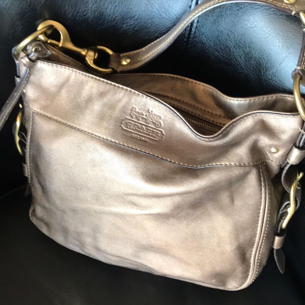 COACH purse in gold with lavender lining.